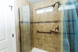 The Arlington Master Featuring Frame Less Shower Door Resin Shower Pan Decorative Accent Strip And Oil Rubbed Bronz Shower Doors Shower Pan Plumbing Fixtures
