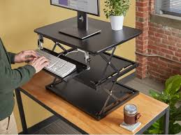 A retractable keyboard tray tucks away below the desktop to create less clutter and protect your keyboard. Tiered Adjustable Standing Desk By Uncaged Ergonomics The Grommet