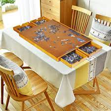 She assembles the puzzle, admires the accomplishment, takes is all apart and returns it to the box, then donates the puzzle to charity for someone else to enjoy. Costway 1500 Pcs Wooden Jigsaw Puzzle Table Plateau Smooth Work Surface W 4 Drawers Walmart Canada