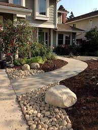 Irregularly placed flagstone pavers offer a path from front door around the side of the house. 31 Front Walkway Ideas To Implement In 2021 A Nest With A Yard