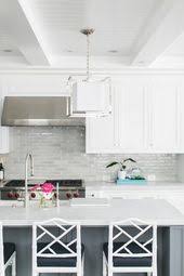 Light Gray Backsplash Tiles Accent White Shaker Cabinets Flanking A Stainless Steel Backsplash For White Cabinets Kitchen Backsplash Designs Kitchen Renovation