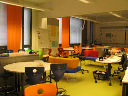 ritaharju school oulu finland two classrooms with a mix of soft furniture and wheeled classroom chairs bright colour scheme limited to furniture and cu ecole