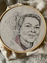 Who is the vendor selling embroidered earrings at the mural festival in  Ponca City?