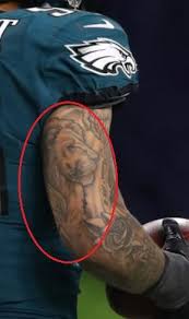 Philadelphia eagles helmet design, small size tattoo at arm. Derek Barnett S 11 Tattoos Their Meanings Body Art Guru