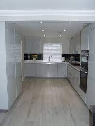 White kitchen with grey floors are still being popular choice for people who really want to have a sleek and elegant kitchen. A Beautifully Bright And Modern Handleless Kitchen In High Gloss Light Grey With Designer White Modern Grey Kitchen Grey Kitchen Designs White Kitchen Interior