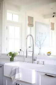 A Farmhouse Sink With A Satin Nickel Pull Out Faucet Is Fixed To Light Gray Peninsula Over Light Gray Shak Farmhouse Sink Farmhouse Sink Faucet Pull Out Faucet