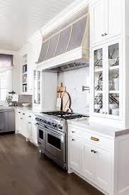 Exquisite Kitchen Features A Steel Kitchen Hood Accented With Brass Trim Which Stands Over A Marble Cooktop Backsplash Kitchen Inspirations Kitchen Hoods Home