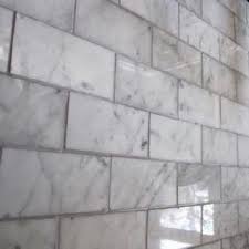 Clean the grout lines 20 to 30 minutes after filling or when the joints begin to harden and dry. White Carrera Marble With Gray Grout White Marble Mosaic Home Decor Tips Home Upgrades