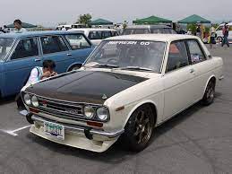 Datsun 510 Looks Like A Proper Eggshell White With Carbon Fiber Hood And Pins Datsun Car Datsun 510 Retro Cars
