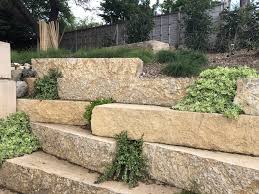 Keep in mind that there are many different types of soils and sands in the various climatic zones on the earth. Staggered Limestone Block Retaining Wall With Succulents Planted Between Spaces Fire Pit Patio Home Landscaping Limestone Block