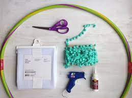 You can easily make your own, even if you aren't a master sewer. No Sew Hula Hoop Canopy With Pom Poms Hometalk