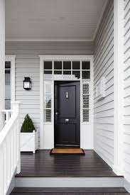 Light Grey Siding White Trim Around Windows And Front Door Black Front Door Dark Hardwood Floors Whit Gray House Exterior Facade House House Paint Exterior