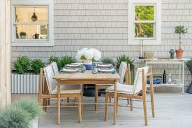 Outdoor patio with dining table and chairs in natural setting
