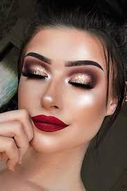 All that glimmers is gold—and when you apply this sparkly hue to your lids, it's the perfect way to complement a classic red lip. Gold Makeup Looks Red Lipstick Makeup Red Lipstick Makeup Blonde