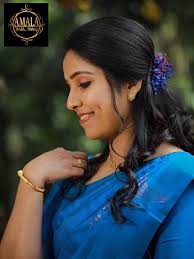 Elegant Engagement Makeup for the gorgeous bride @Asha Joseph clad in Blue  saree coupled with stylised make-up, a stunning hairdo embellished with  matching dry flower completes the pretty picture. Bridal Styling :