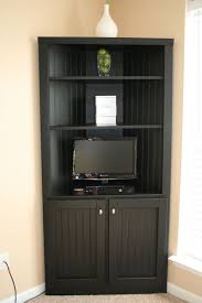 Crafted from solid and manufactured wood, it's finished in an oak veneer and features glass doors for easy collection viewing. Living Room Corner Storage Cabinet Novocom Top
