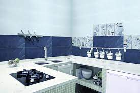 A galley kitchen with a dual tone blue and beige combination features a letter box window opening to the kitchen garden. Kitchen Wall Tiles Ideas India Novocom Top