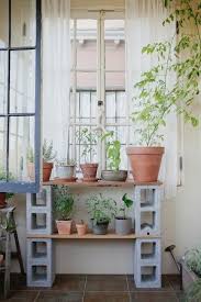 12 Tables Made With Cinder Blocks Economy Edition Remodelista Cinder Block Furniture Cinder Block Garden Plant Shelves