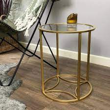 Made of metal, this side table has a round design with a metallic gold textured finish. Distressed Gold Round Side Table Farthing The Farthing