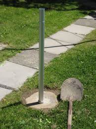 Greek statue and american flag front yard. How To Install A Flagpole