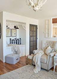 White furnishings, accented with gray and blue, give the gulfside cottage space carefree spirit. Farmhouse Style Living Room Simple Cottage Decor With Neutrals And Vintage De Cottage Style Living Room Farmhouse Style Living Room French Country Living Room