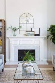 Full mantels include both the top shelf and legs that frame the top and sides of the fireplaces. Arch Mirror Over White Classic Fireplace Mantel Transitional Living Room