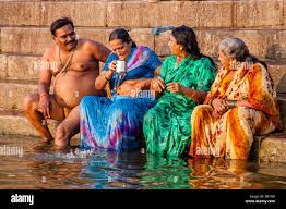 Hindu Pilgrims Bathing In The Holy River Ganges, Varanasi, Uttar Pradesh,  India Stock Photo 