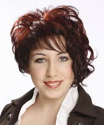 As curls can coil in unpredictable ways, cutting a style that appears uneven yet balanced can be challenging. Short Curly Dark Red Asymmetrical Hairstyle With Asymmetrical Bangs
