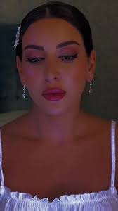 Elegant Indoor Fashion: Ruffled Garment and Earrings