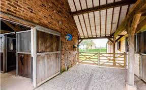 This barn features six stalls, a treadmill, office, laundry, bathroom. Top Equestrian Homes Property Blog
