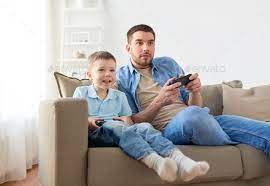 Father And Son Playing Video Game At Home By Dolgachov On Photodune Family Fatherhood And People Concept C Happy Fath Father And Son Playing Video Game Sons