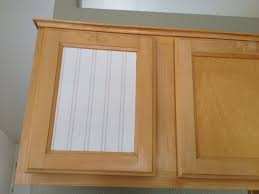 Adding beadboard wallpaper to the center section of the cabinets. Weathered Or Not Kitchen Cabinet Makeover Tutorial Kitchen Cabinets Makeover Cabinet Makeover New Kitchen Cabinets