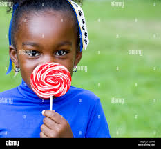 Girl hiding candy hi-res stock photography and images