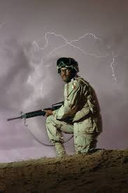 US Army (USA) Private First Class (PFC) Ray Brownlee stands a night watch  at Forward Operating