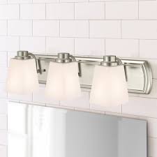 A frosted glass lamp shade creates a beautiful diffused light, an ideal choice for bedside tables or cozy reading nooks. Modern Bathroom Light Fixtures Destination Lighting