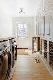 Shop storage racks, washroom space. A White Front Loading Washer And Dryer Are Enclosed Beneath A Countertop And Positioned Facing Stacked Gray Shop Interiors Mudroom Laundry Room Room Renovation
