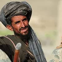 A Pashtu Abad School student smiles after learning