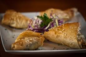 Sliced gyro, 5 skewers of marinated charbroiled chicken, half pint hummus, half pint tzatiki sauce Greek Taverna