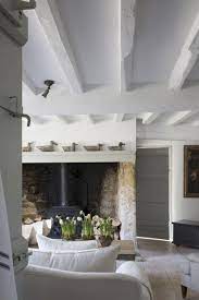 The wall paneling is hawthorne yellow, and the trim is white. How To Lighten Wooden Beams Earthborn Paints