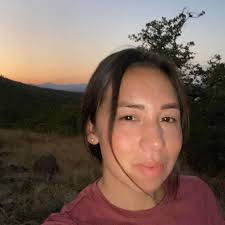 Southwest Museum archaeologist Anne Watkins holds an enormous obsidian  blade, found by the Wilder brothers (Karok Indians) after it was unearthed  by an earthquake in northern California, purchased by Gen. Charles Reeve