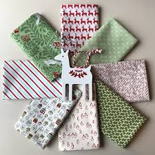 Fabrics are in reds, greens, gold, blue and cream. Reindeer Frolic Christmas Fat Quarters