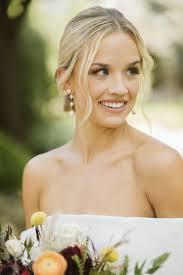 Blonde Loose curls with low bun wedding hairstyles