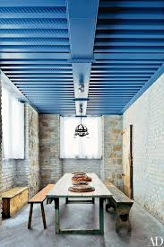 Shades of yellow, including soft butter yellow and rich mustard yellow, offer warmth and brilliance that stands out vividly against the cool, deep tones of navy blue. Why Blue Ceilings Are Such A Popular Tradition Architectural Digest