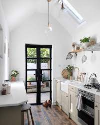 A leather armchair, hide throws and an inglenook fireplace in the sitting room; Small Galley Kitchen Ideas Love Renovate