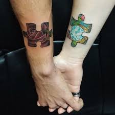 Red heart on the hands. Super Tattoo Ideas For Couples Puzzle 40 Ideas
