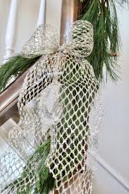 This banister greenery in the entryway gets a touch of sparkle with 1950s favorites like shiny brite ornaments. How To Hang Garland On Your Banister Summer Adams
