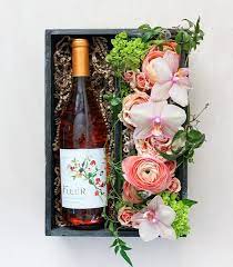 Floral expressions of lilac and fresh roses. A Beautiful Bottle Of Fleur Pinot Noir Rose Is Tucked Alongside A Whimsical Design Of Garden Roses Orchids Sp Flowers Wine Champagne Gift Baskets Wine Gifts