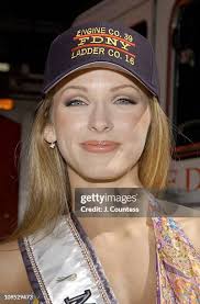 Shandi Finnessey, Miss USA 2004 poses with Firemen Phil Larimore,... News  Photo