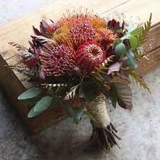 In addition to this, the availability of your selected blooms is a major factor that must be. Red And Gold Summer Natives For A December Wedding Wedding Bouquets Bride Australian Native Flowers Bridal Bouquet