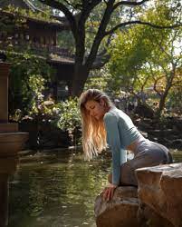 Nata Lee #women #model #blonde long hair #fountain #water #trees Asian  architecture crop top #skirt #kneeling painted nails #outdo… | Model, Long  hair styles, Women